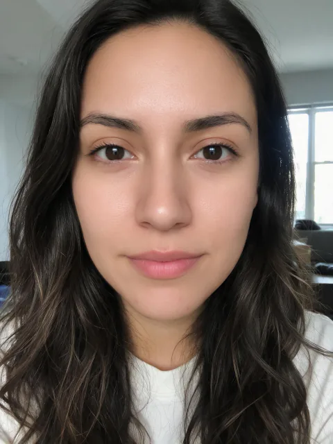 The woman's same selfie with Beautify Me at Balanced: skin and under-eyes retouched; hair, clothes and background unchanged